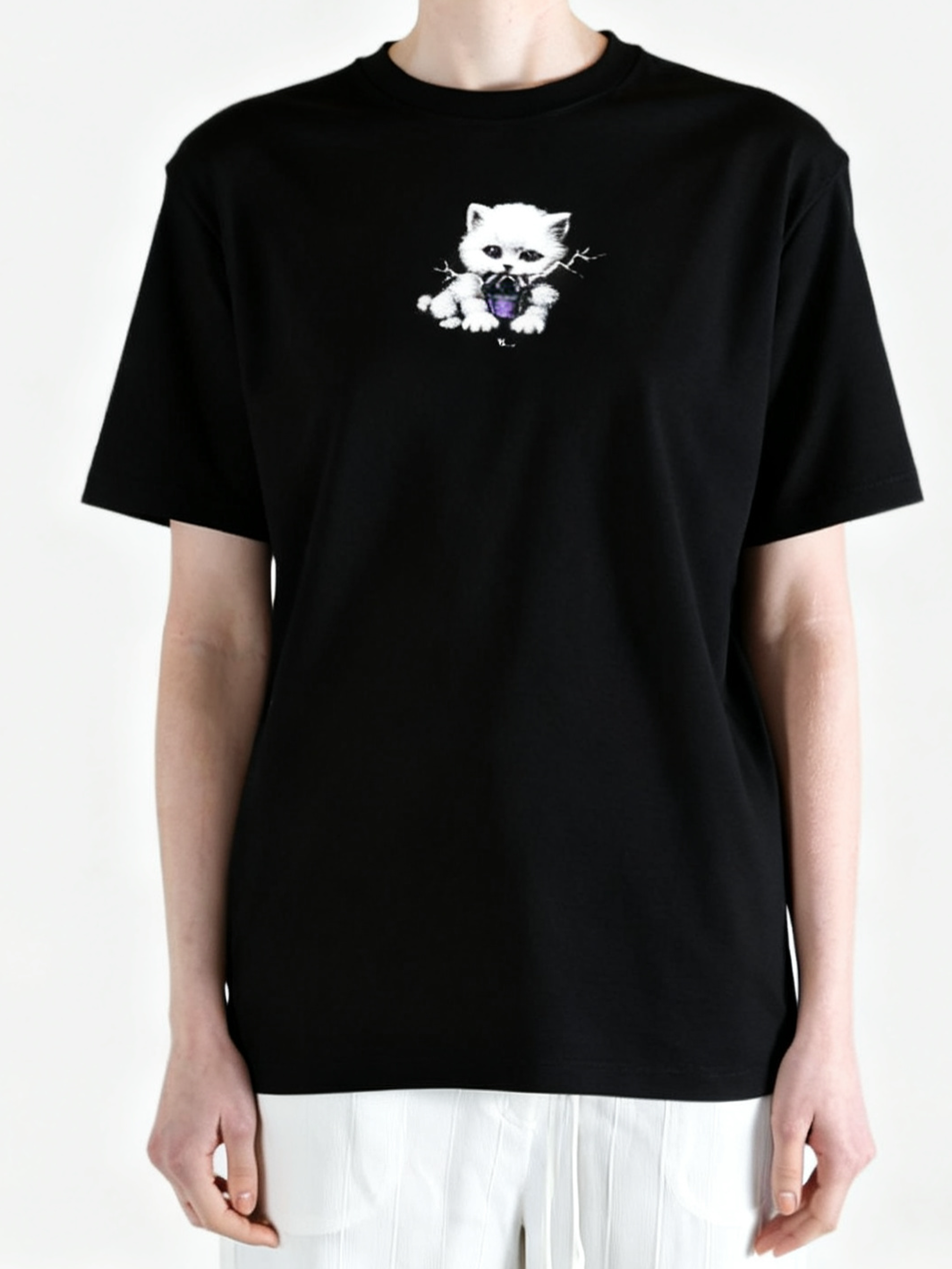 Black top worn by a person, showing the top fit