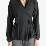 Grey tops worn by a person, showing the tops fit