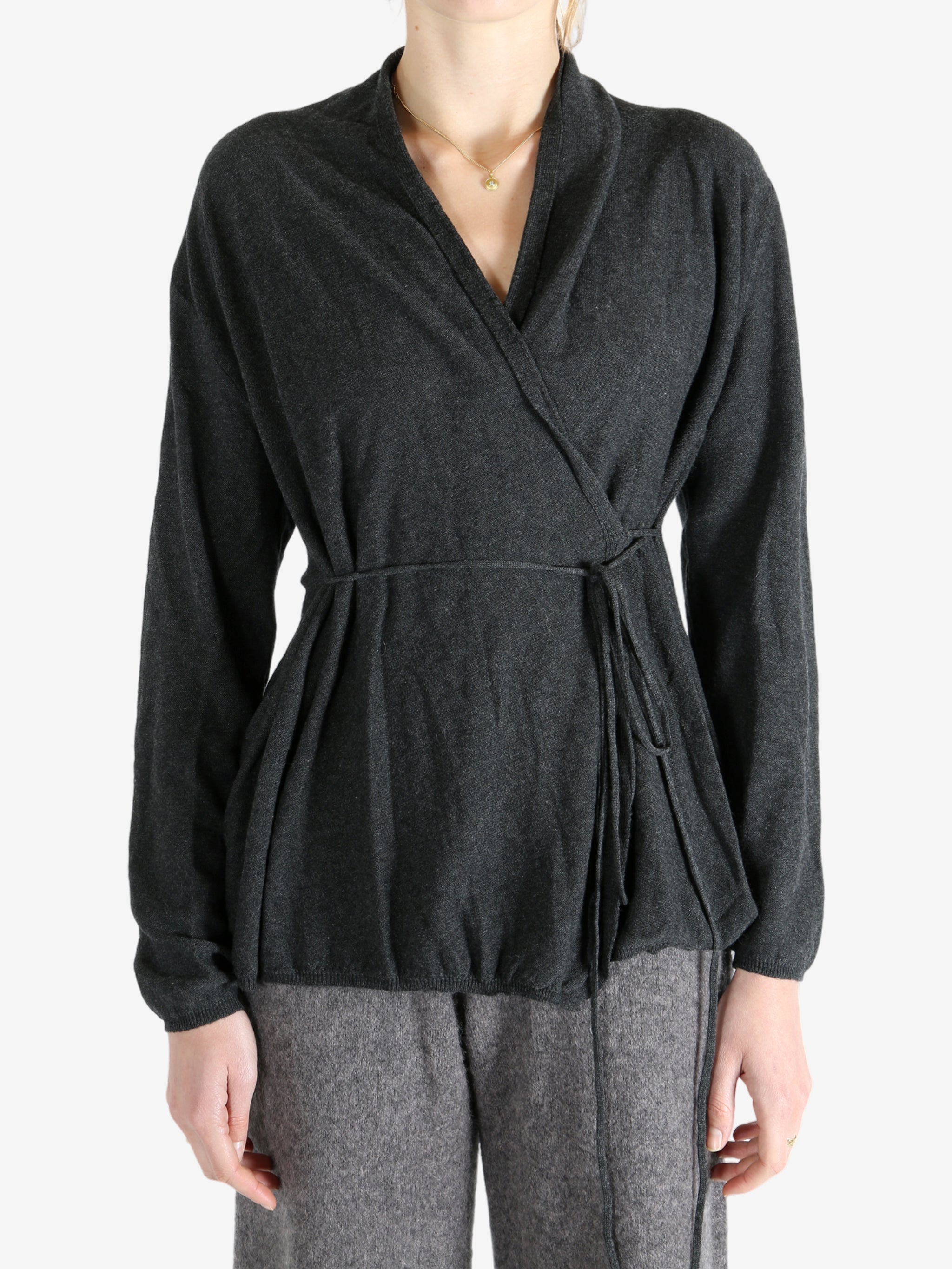 Grey tops worn by a person, showing the tops fit