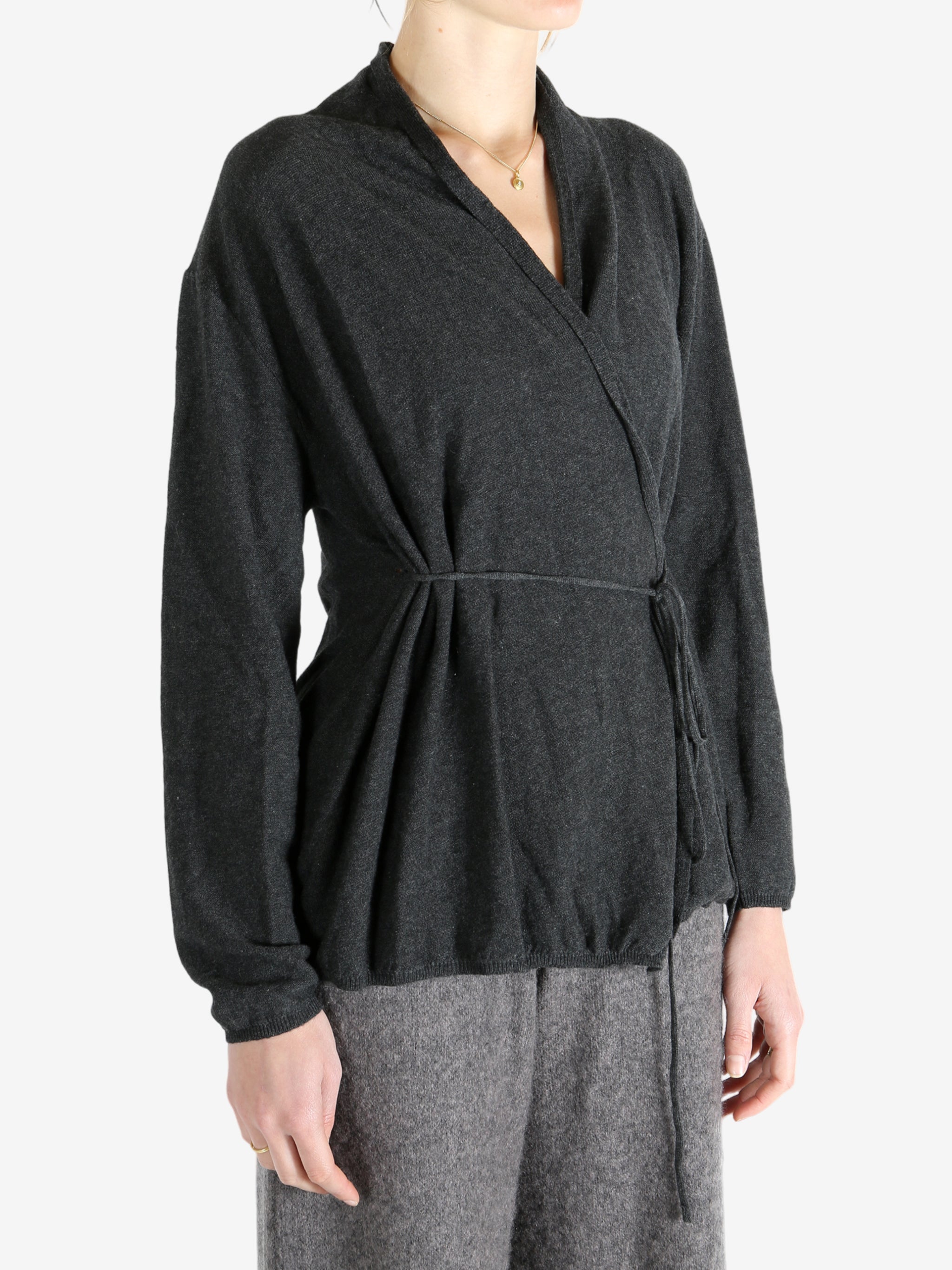 Grey tops worn by a person, showing the tops fit