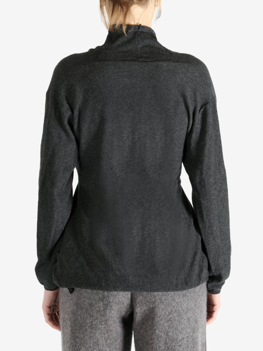 Grey tops worn by a person, showing the tops fit