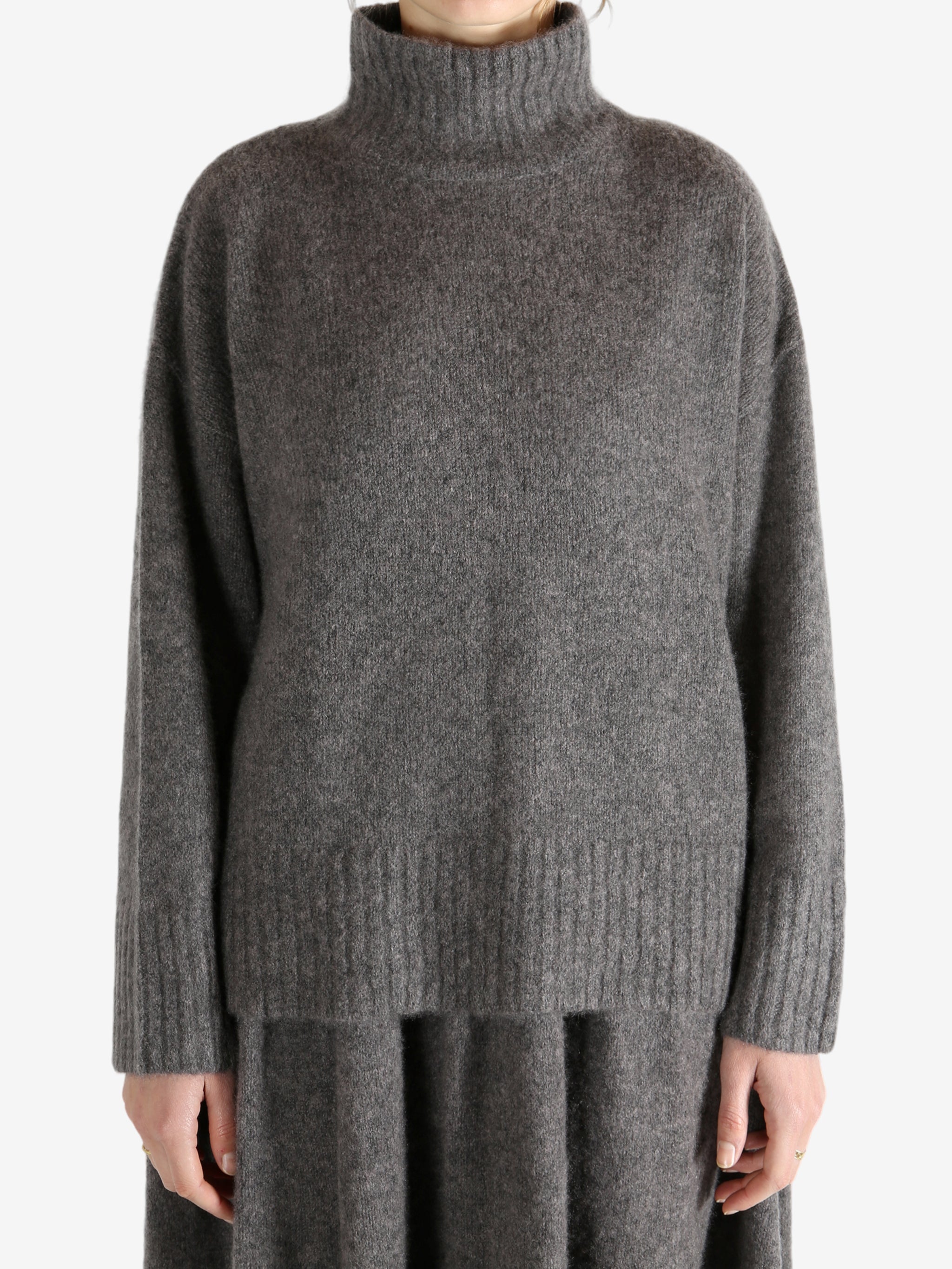 Grey top worn by a person, showing the top fit