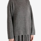 Grey top worn by a person, showing the top fit