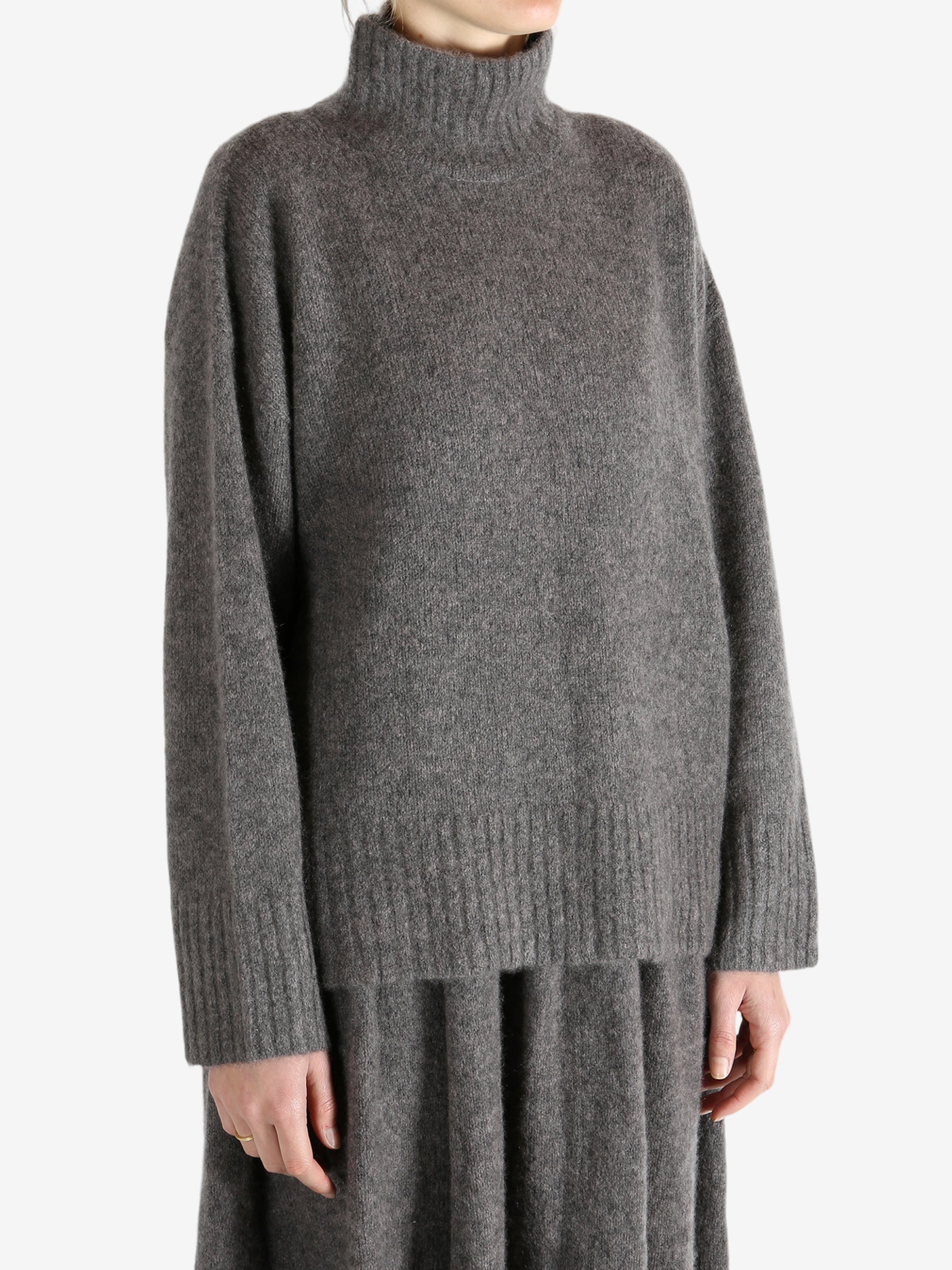 Grey top worn by a person, showing the top fit