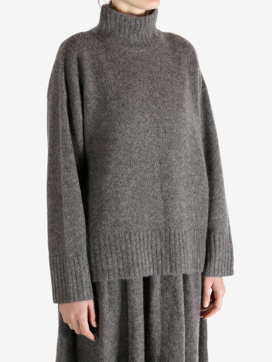 Grey top worn by a person, showing the top fit