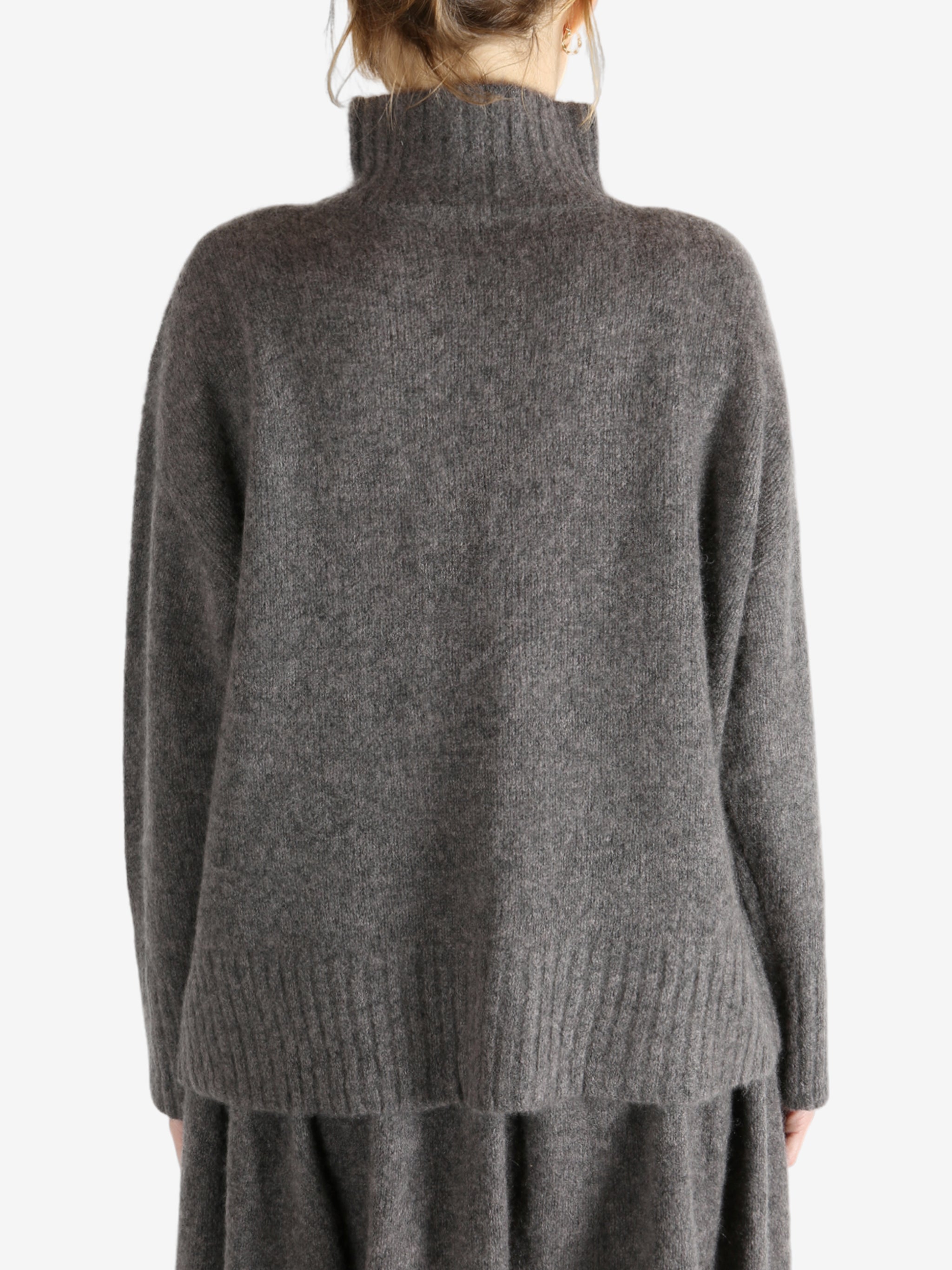 Grey top worn by a person, showing the top fit