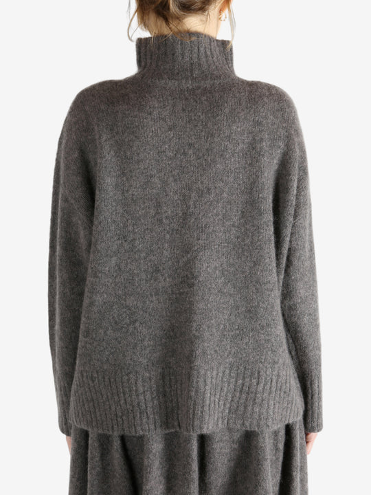 Grey top worn by a person, showing the top fit