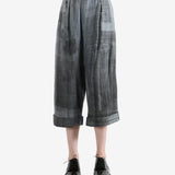 Grey pants worn by a person, showing the pants' fit