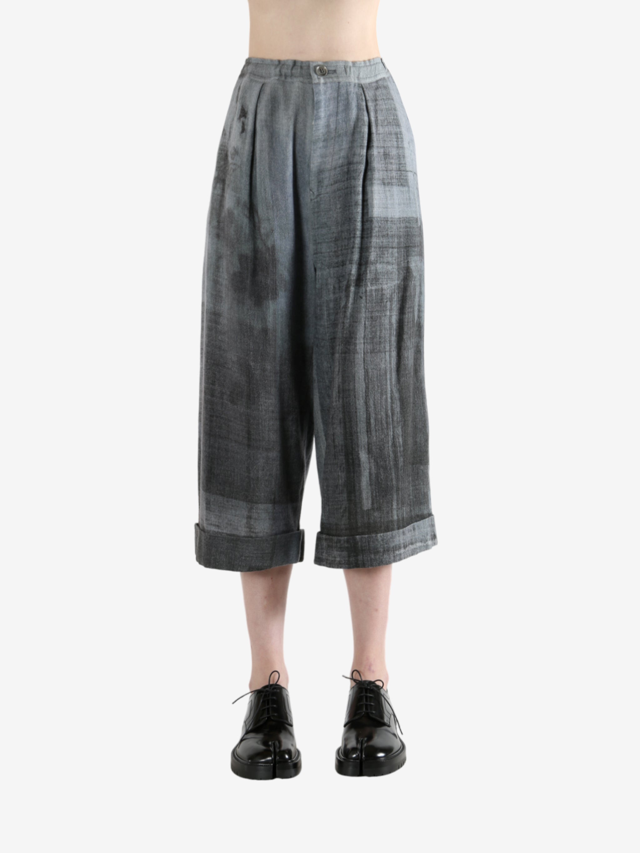 Grey pants worn by a person, showing the pants' fit