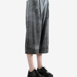 Grey pants worn by a person, showing the pants' fit