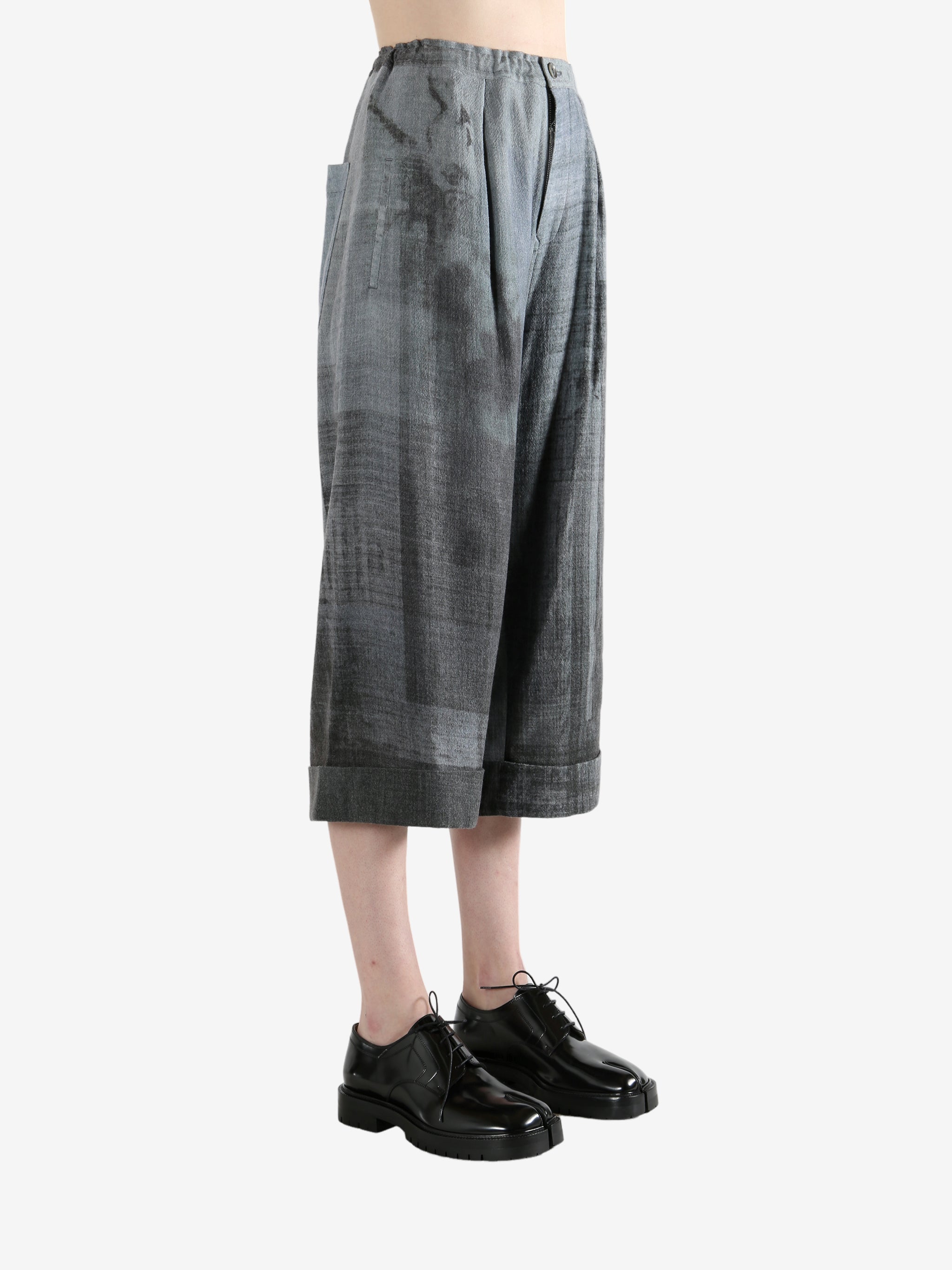 Grey pants worn by a person, showing the pants' fit