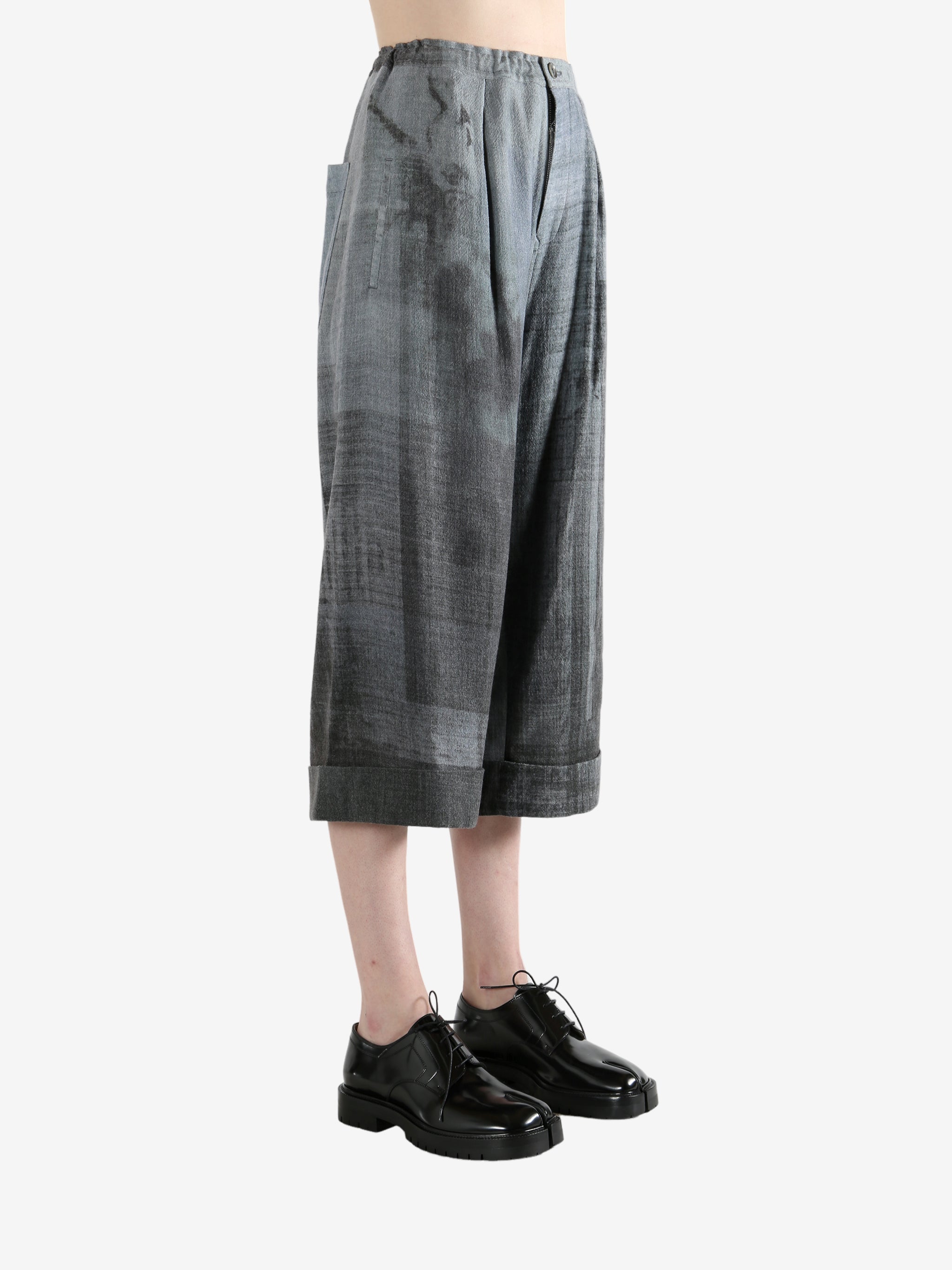 Grey pants worn by a person, showing the pants' fit