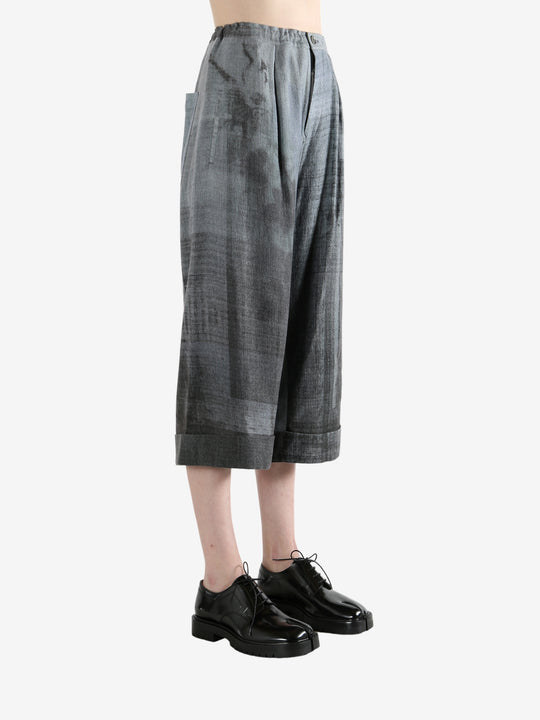 Grey pants worn by a person, showing the pants' fit