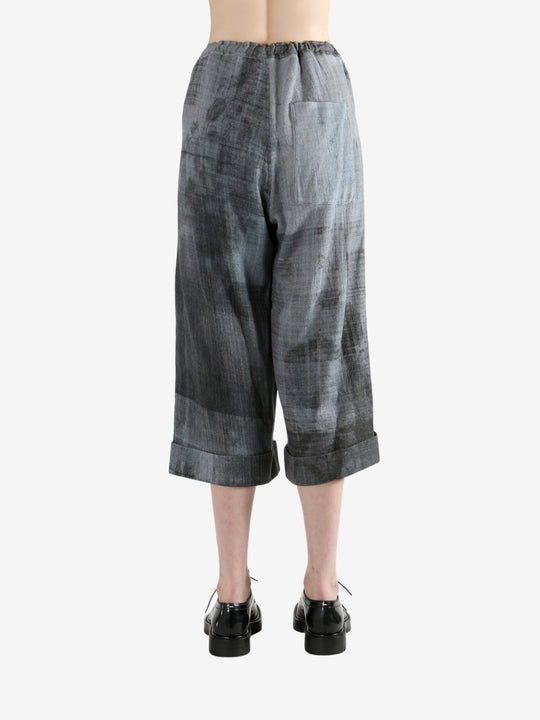 Grey pants worn by a person, showing the pants' fit