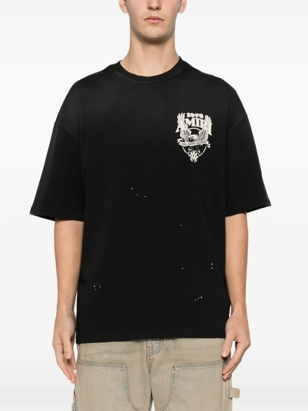 Black t-shirt worn by a person, showing the shirt's fit