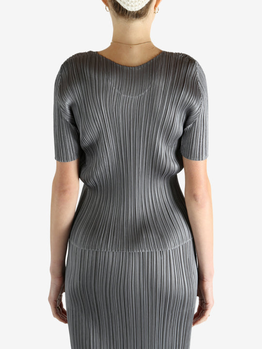 Grey shirts worn by a person, showing the shirts fit