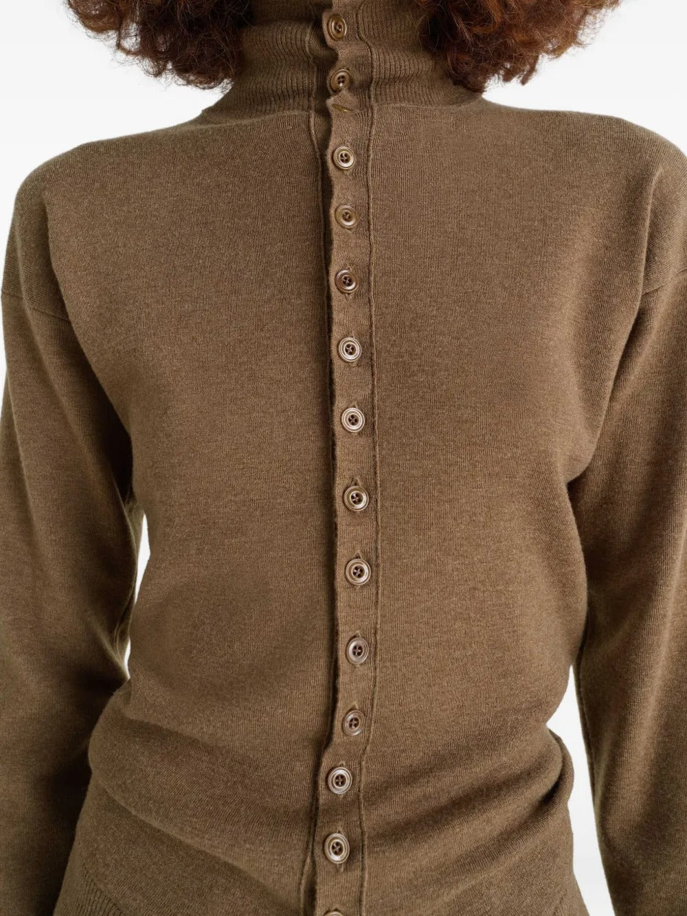 Close up of brown knitwear, showing texture of the wool fabric