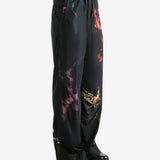 Black pants worn by a person, showing the pants' fit