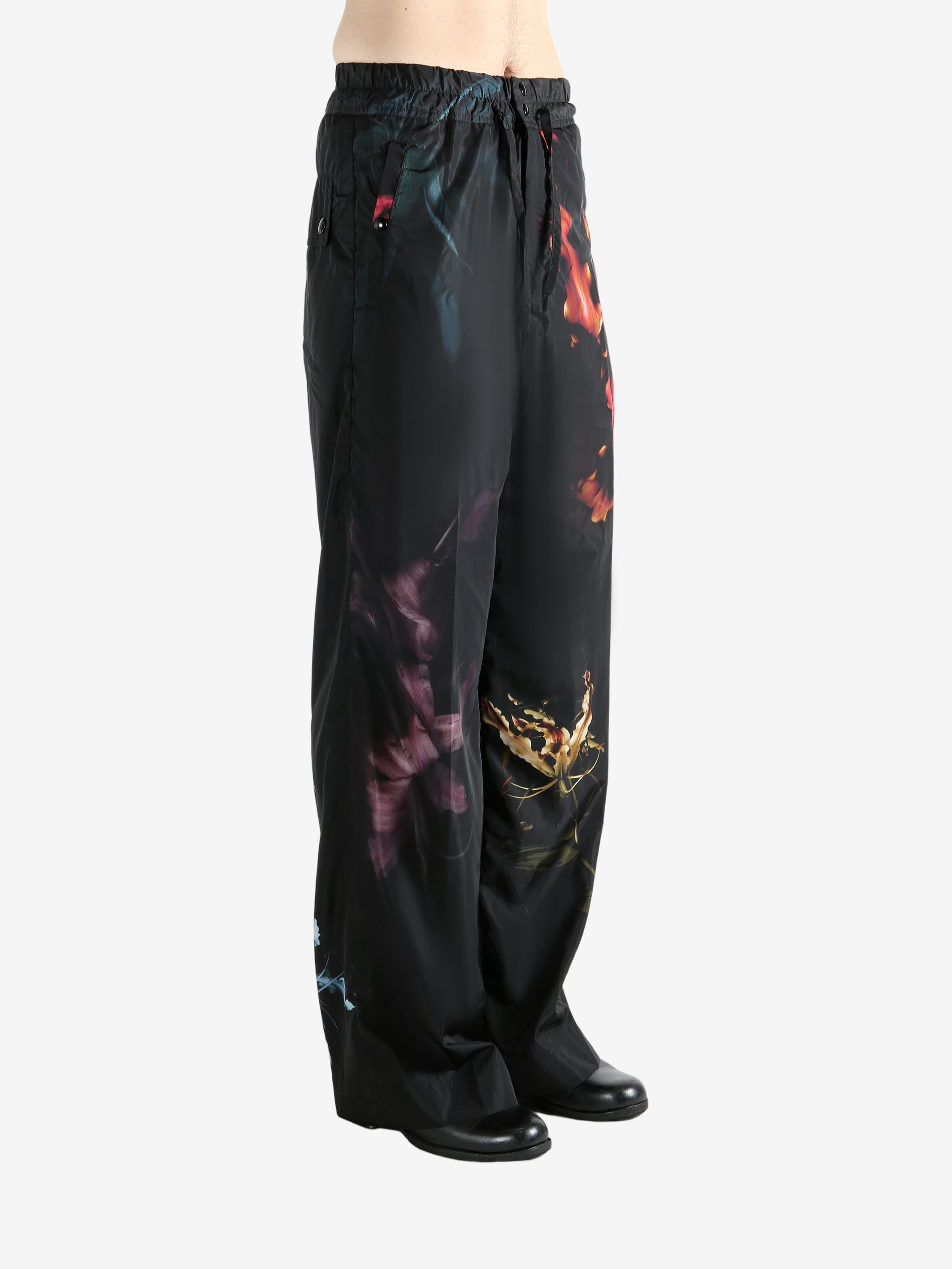 Black pants worn by a person, showing the pants' fit