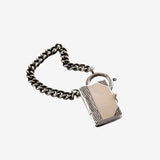 Close up of the grey charm, showing texture of the silver fabric