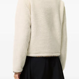 Tan jacket worn by a person, showing the jacket fit