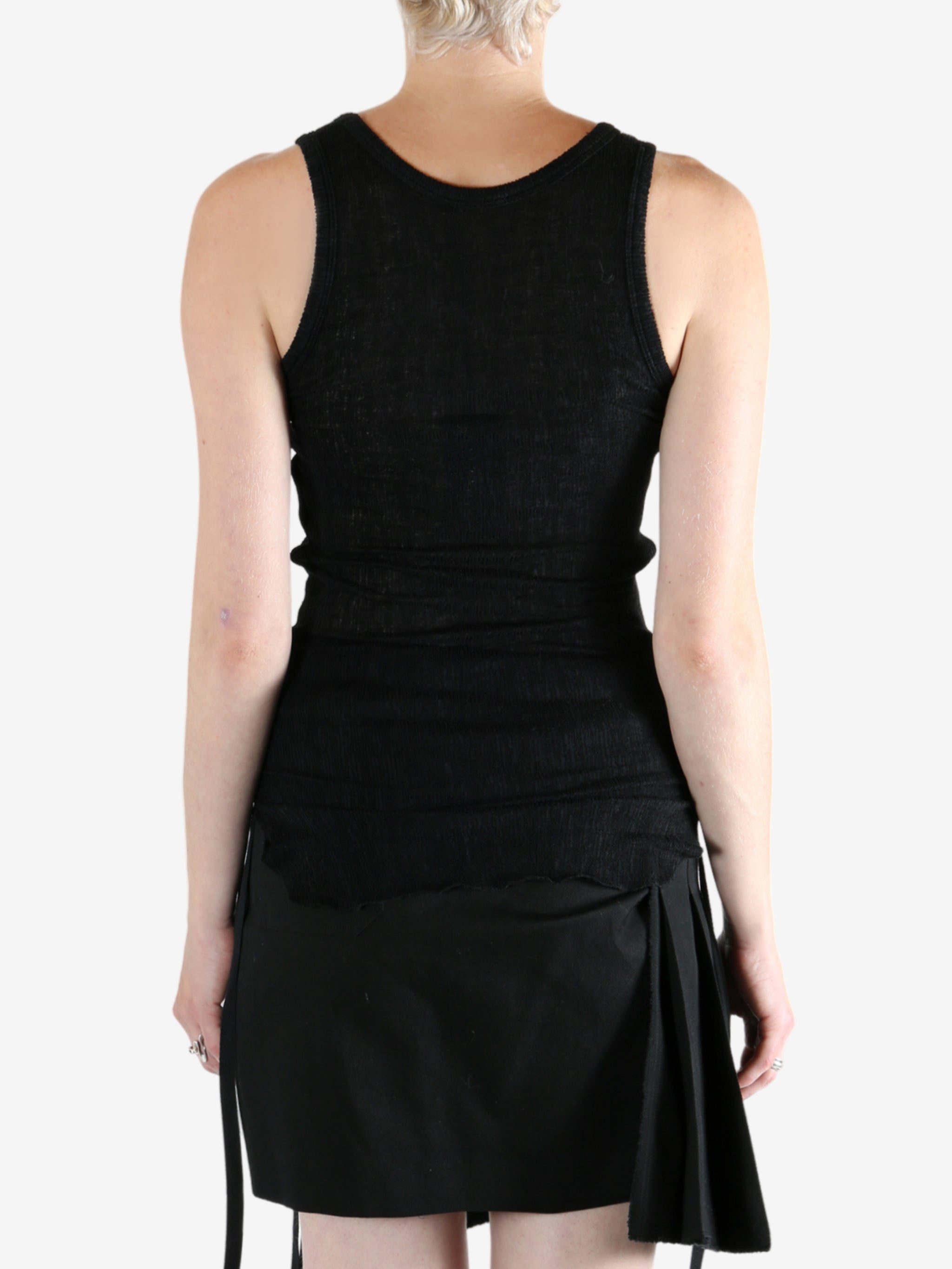 Black top worn by a person, showing the top's fit
