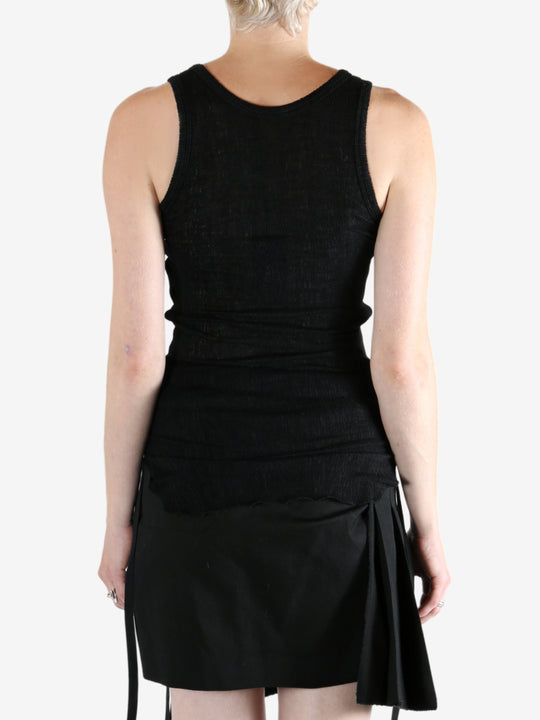 Black top worn by a person, showing the top's fit
