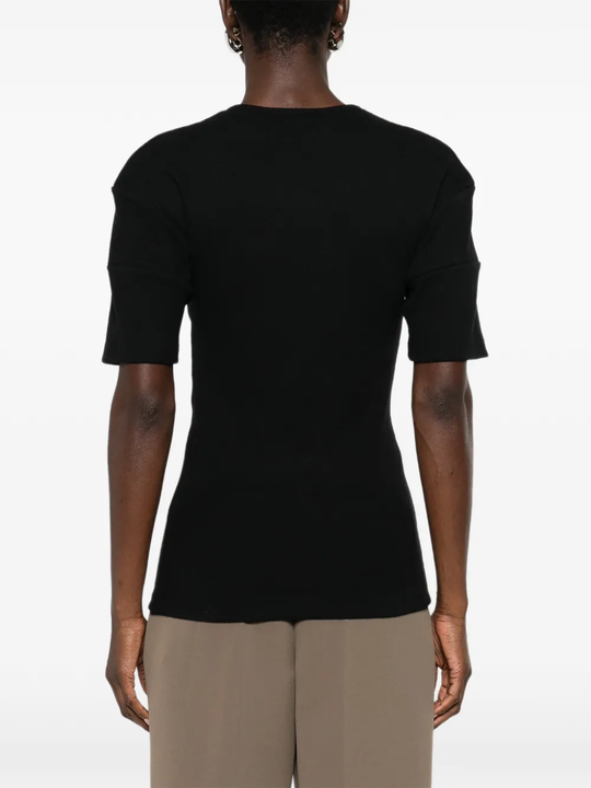 Black shirt worn by a person, showing the shirt's fit