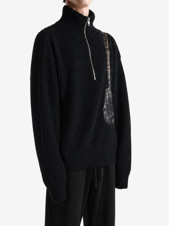 Black knitwear worn by a person, showing the knitwear fit