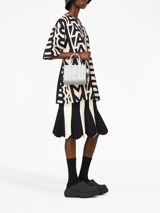 White bag worn by a person, showing the bag's fit