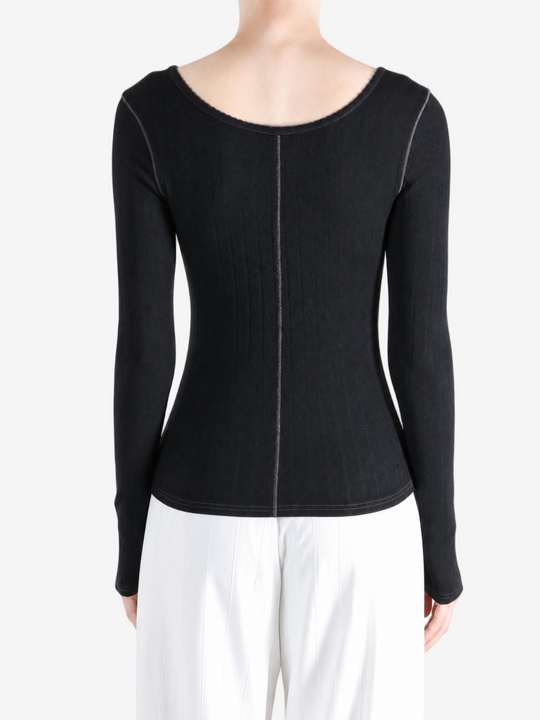Black knitwear worn by a person, showing the knitwear fit