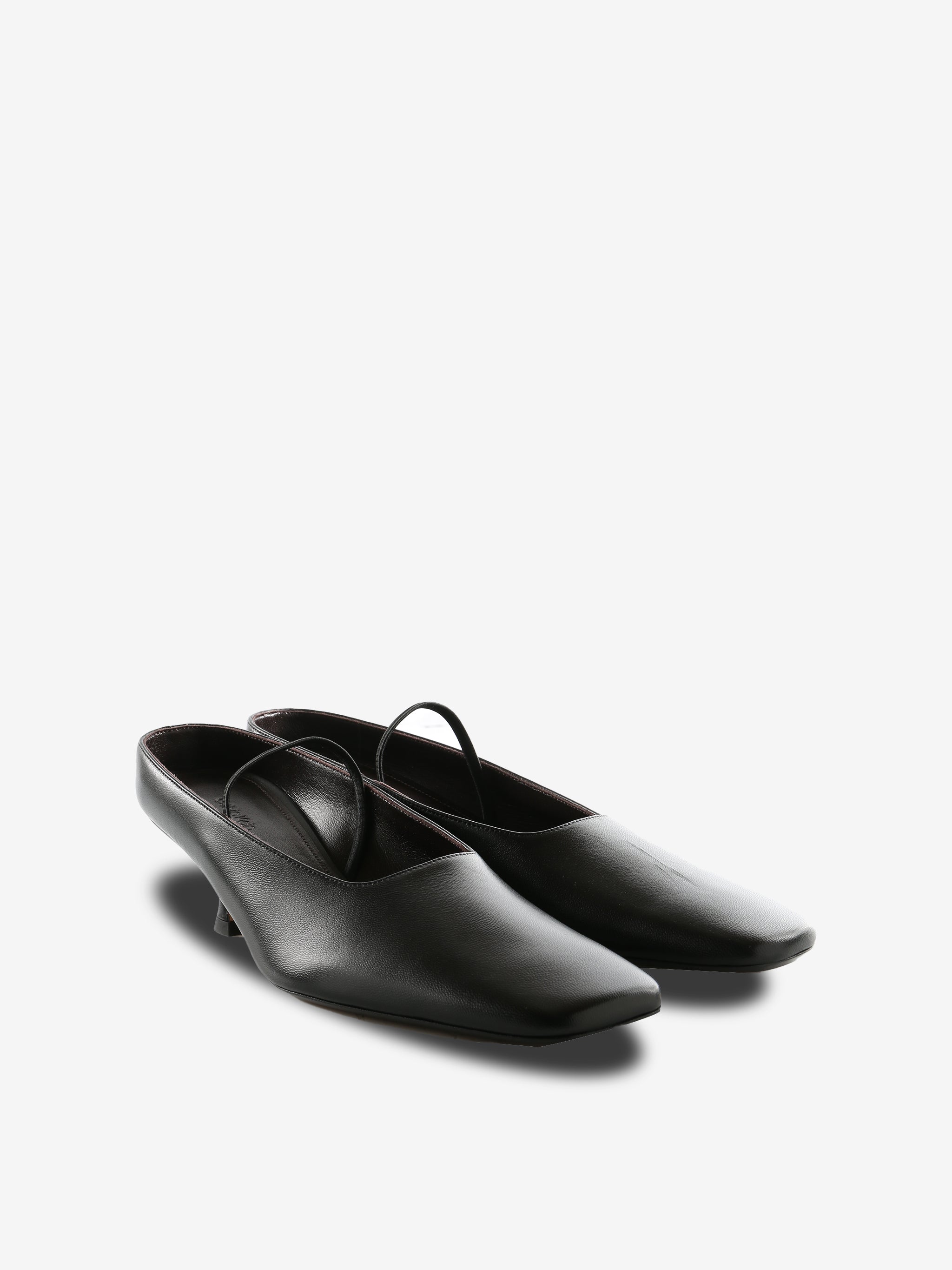 Black mules, side view