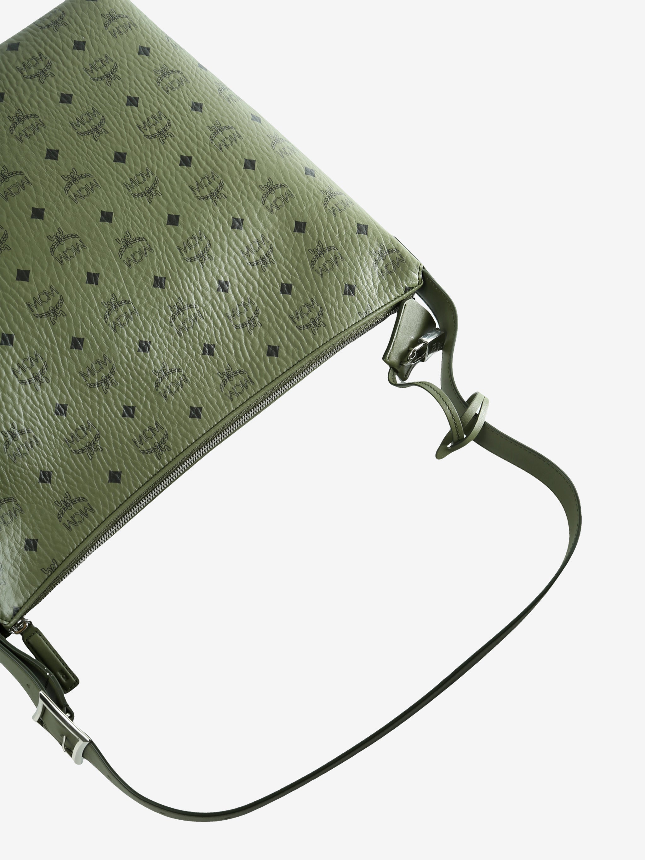 Close up of green bag, showing texture of the leather fabric
