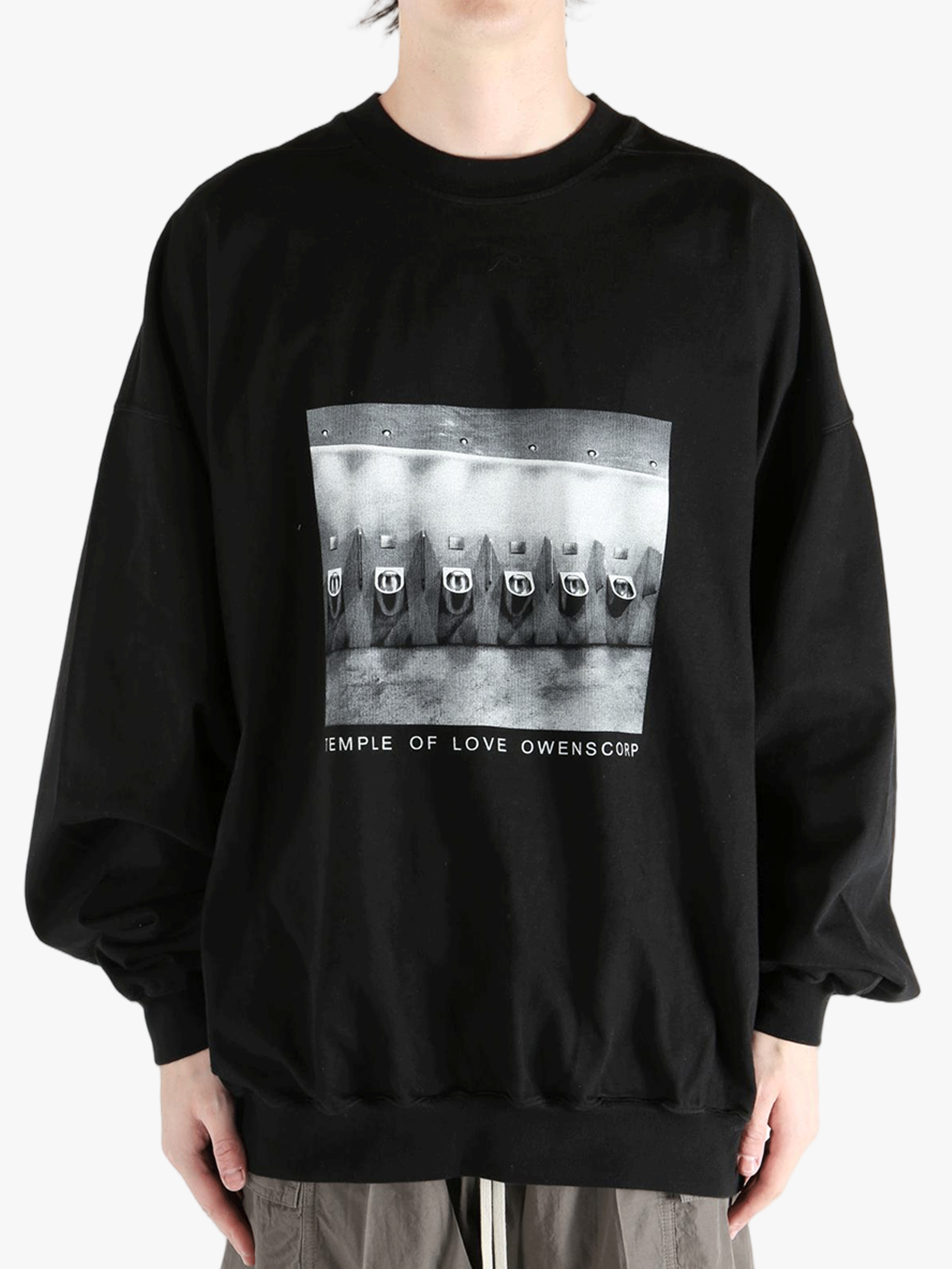 black t-shirts  worn by a person, showing the t-shirts fit