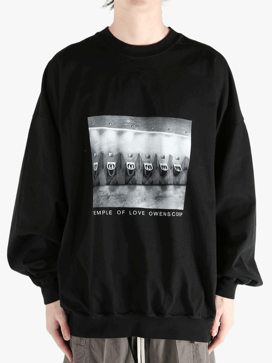 black t-shirts  worn by a person, showing the t-shirts fit