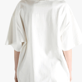White t-shirt worn by a person, showing the t-shirt's fit