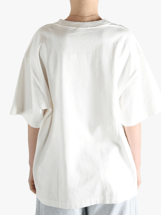 White t-shirt worn by a person, showing the t-shirt's fit
