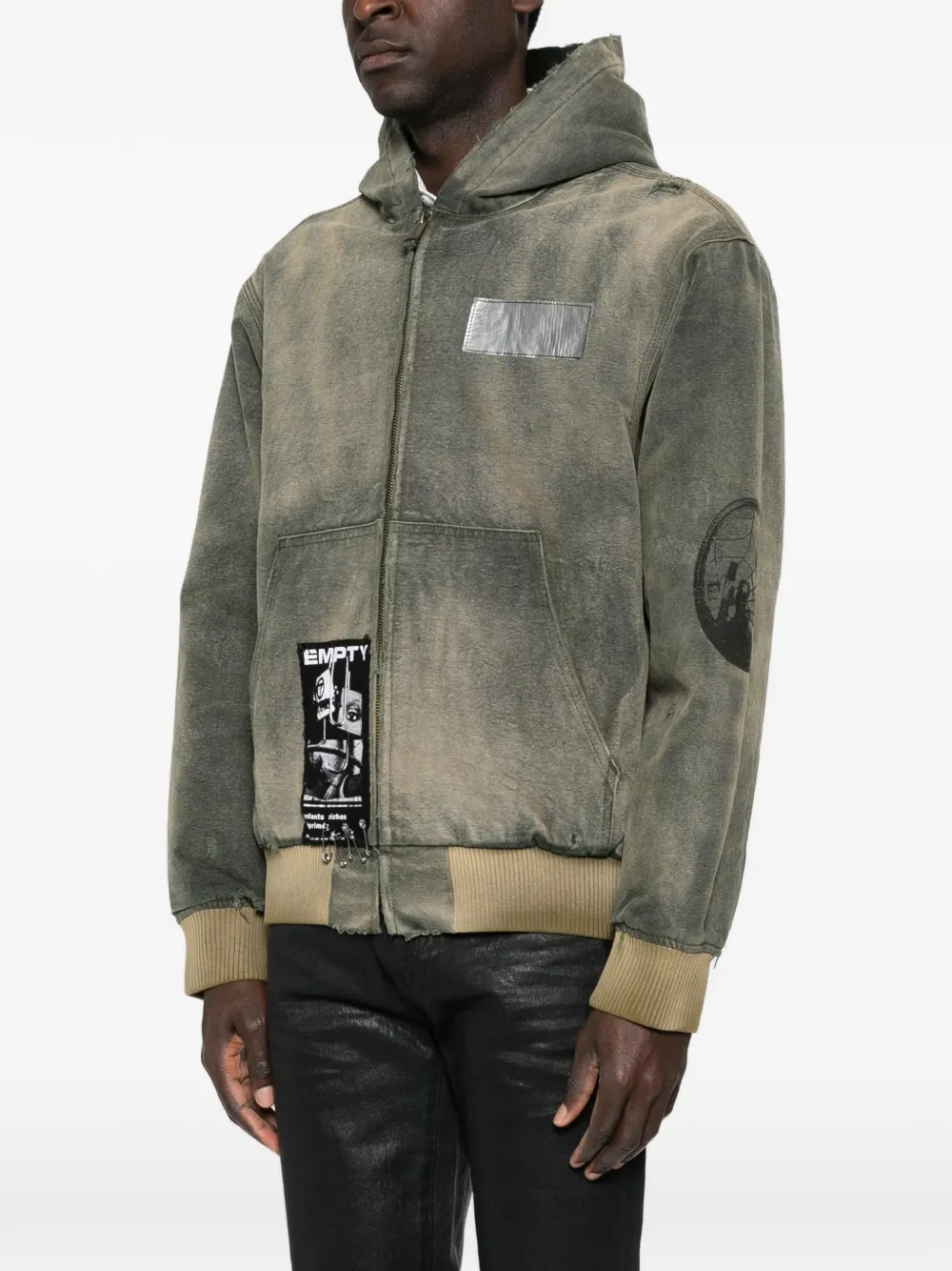 Green jacket worn by a person, showing the jacket fit