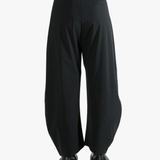 Black pants worn by a person, showing the pants' fit