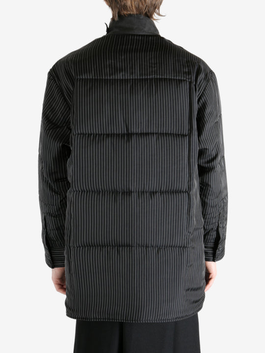 Black coat worn by a person, showing the coat's fit