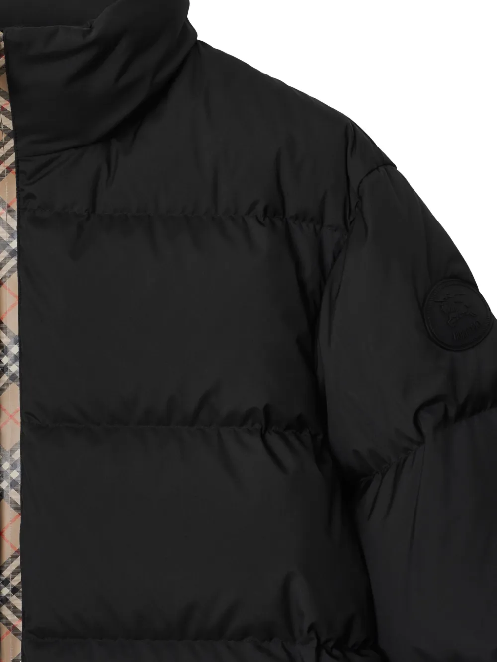 Close up of black coat,showing texture of the polyester fabric.