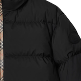 Close up of black coat,showing texture of the polyester fabric.