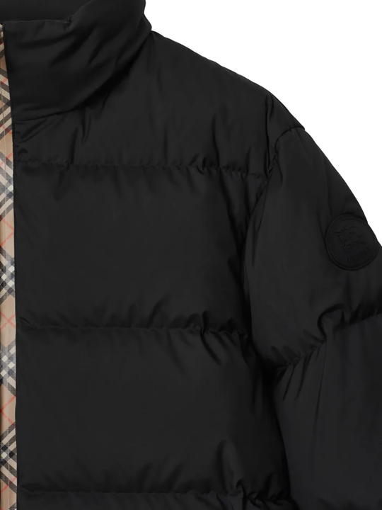 Close up of black coat,showing texture of the polyester fabric.