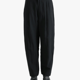 Black pants worn by a person, showing the pants fit