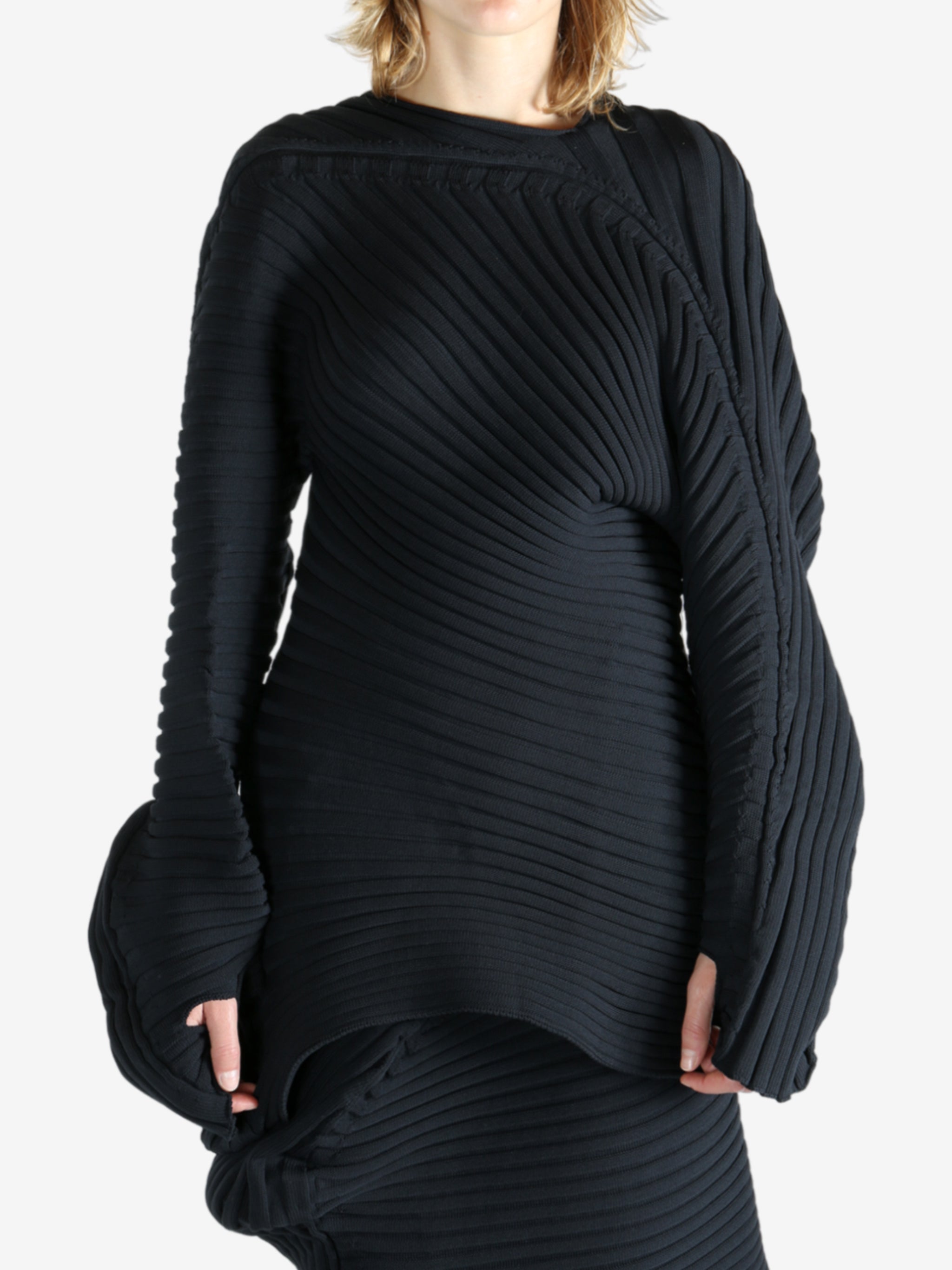 Black top worn by a person, showing the top fit