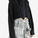 Black coats worn by a person, showing the coats fit