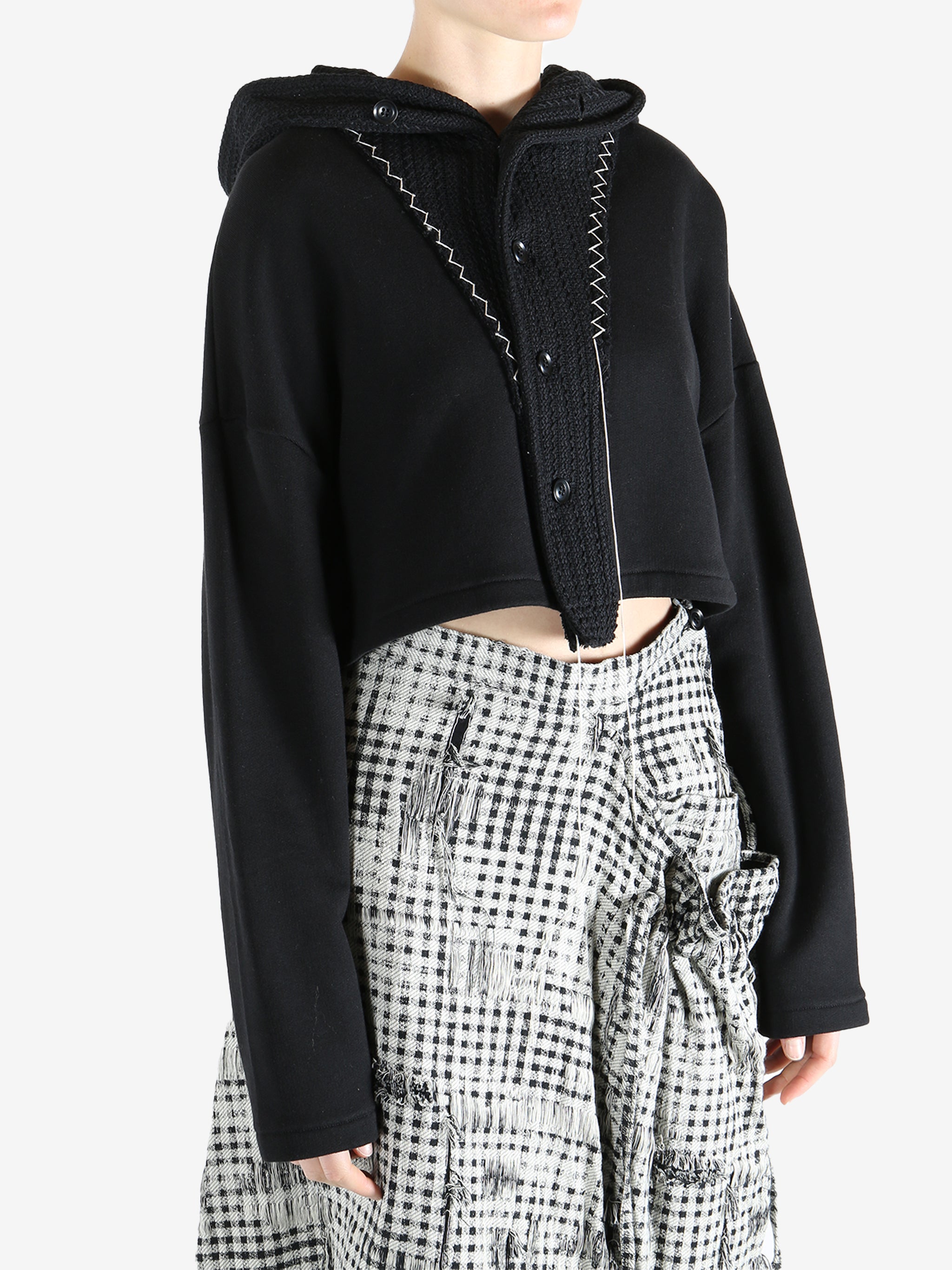 Black coats worn by a person, showing the coats fit