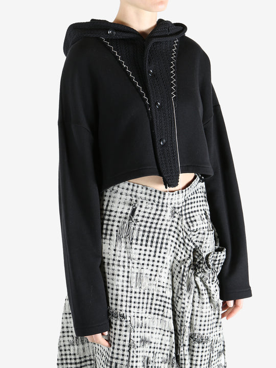 Black coats worn by a person, showing the coats fit