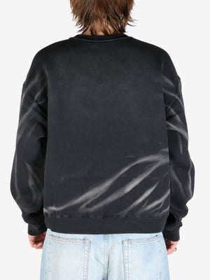 Black sweatshirt worn by a person, showing the sweatshirt's fit