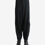 Black pants worn by a person, showing the pants's fit